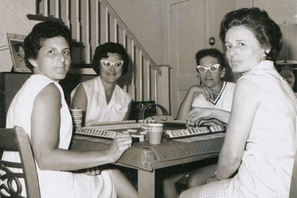 Black and white photo of four American women playing mahjong