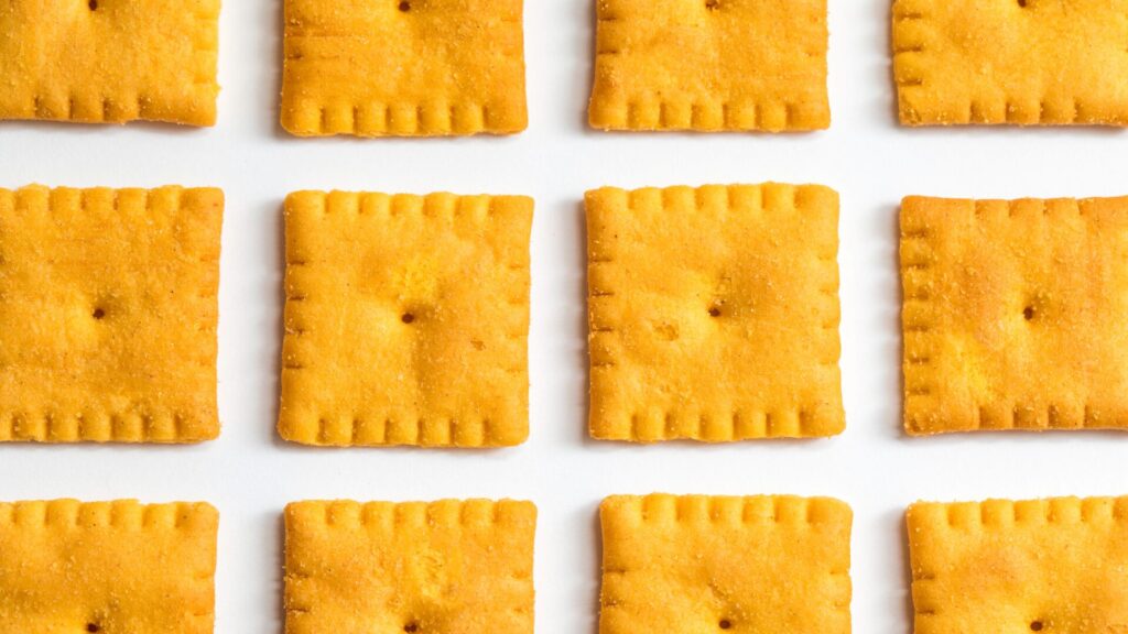 Rows of square cheese flavored crackers